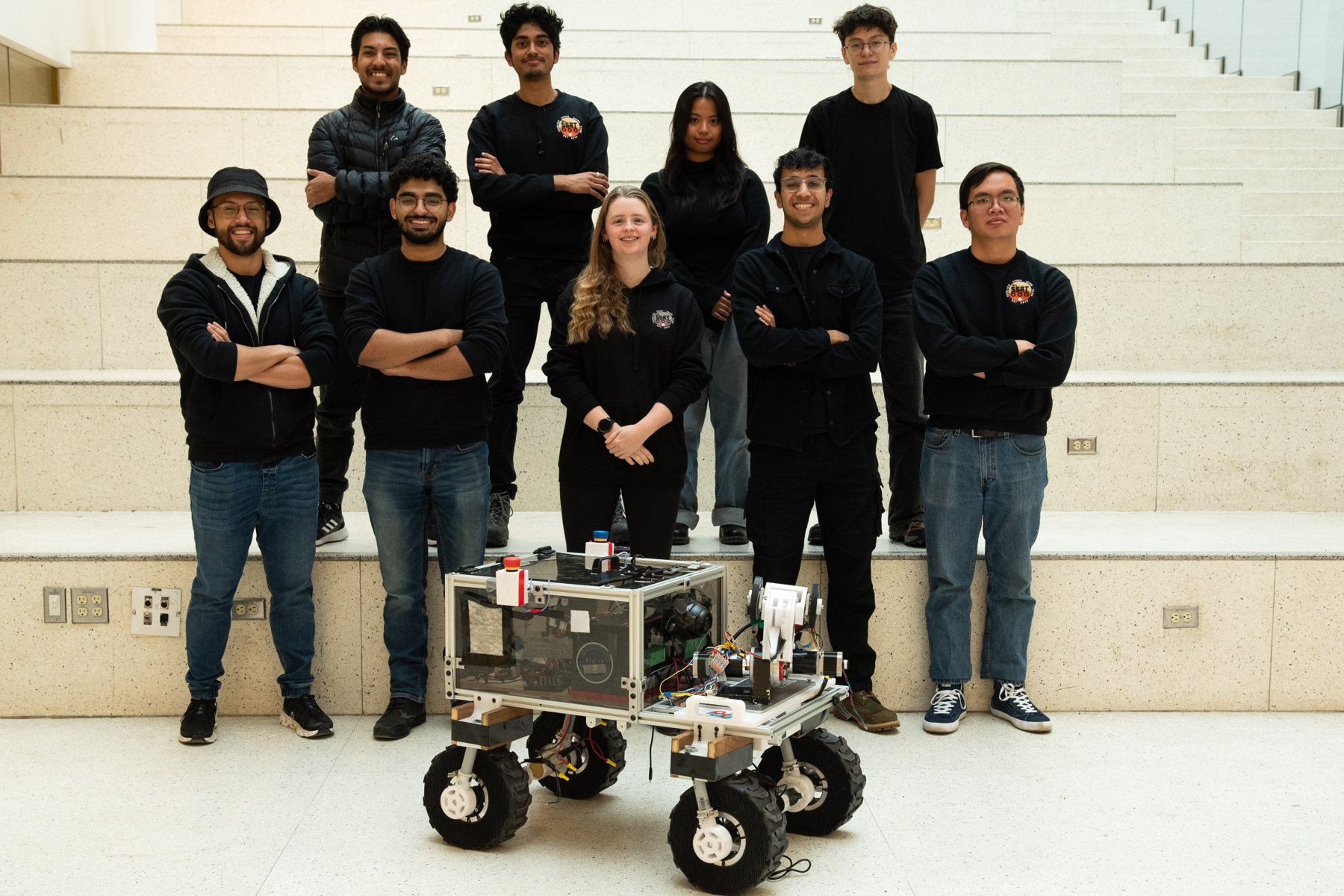 SSRT members standing with the rover